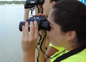Emma Garvey (background) and Kaitlyn Jaeger, from West Genesee School District, try to spot waterbirds and shorebirds.
